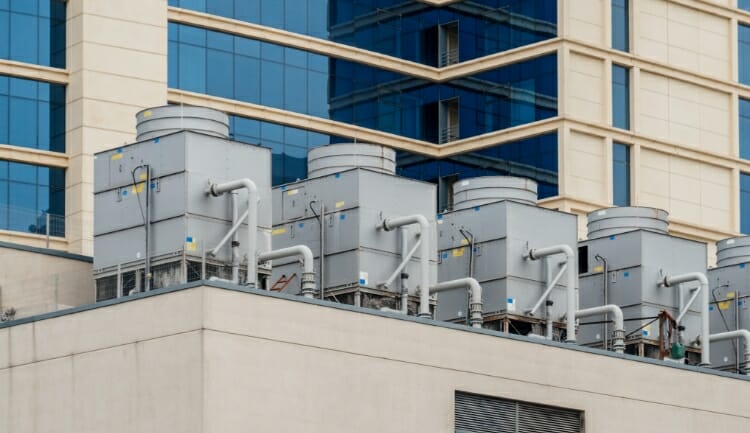5 commercial HVAC units atop a multi-story building