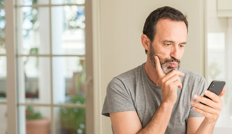 man looking confused at his phone
