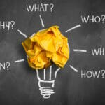 crumpled paper on a blackboard with the words "when, why, what,