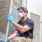 hvac worker replacing air filter