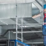 commercial hvac worker installing system